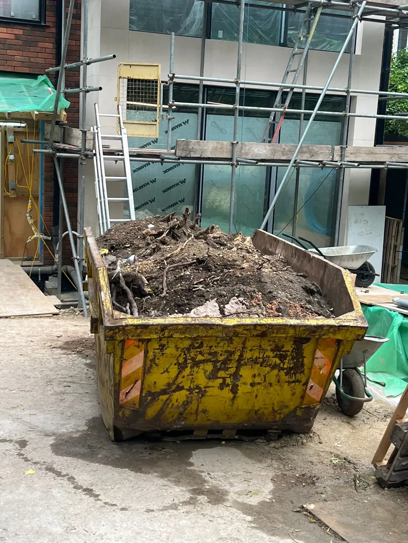 8-yard skip filled with soil and rubble ready for collection in St Mary’s Avenue, Redbridge, E11